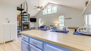 A kitchen with a wooden countertop, blue cabinets, and a ceiling fan. - 'gabbi's Getaway' - Little Tallapoosa River Cabin (Wedowee)
