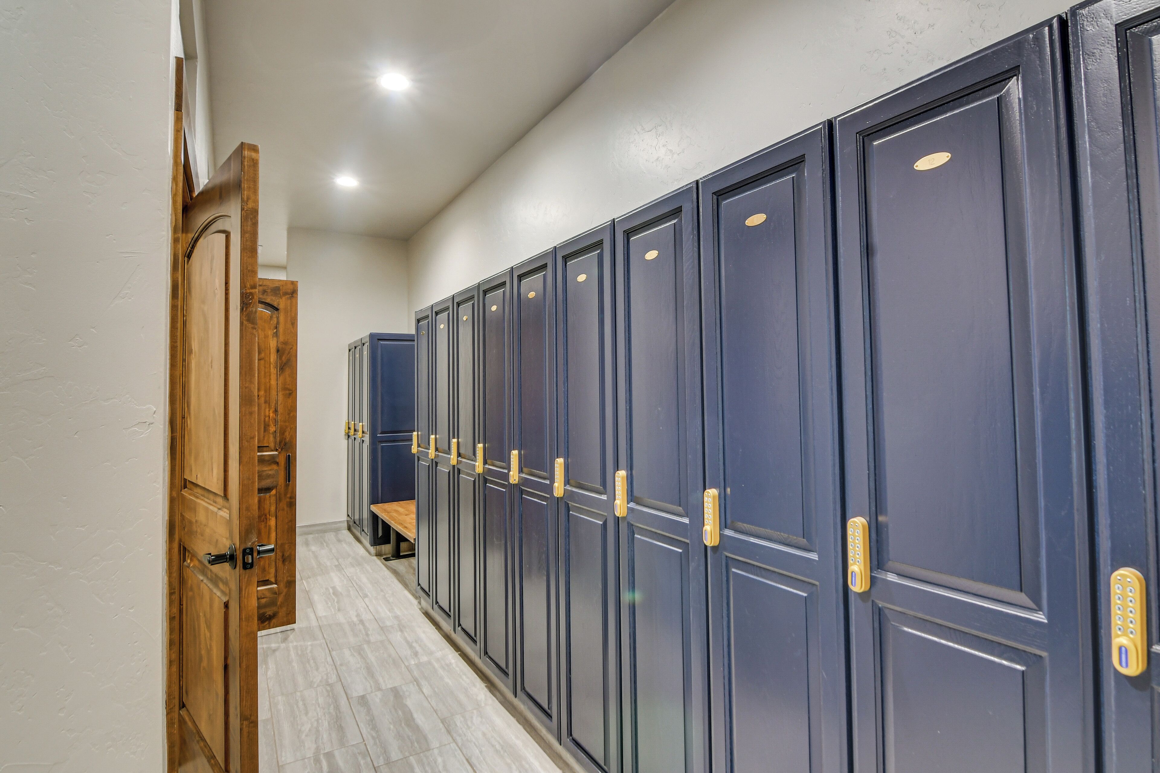A hallway with lockers and a wooden door.