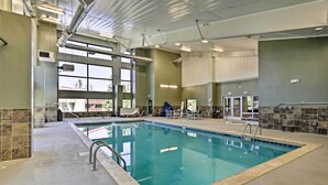 An indoor swimming pool with clear glass walls, a tiled floor, and a ceiling with visible ductwork and lighting fixtures. - Cozy Winter Park Condo ~ 2 Mi to Ski Lifts! (Winter Park)