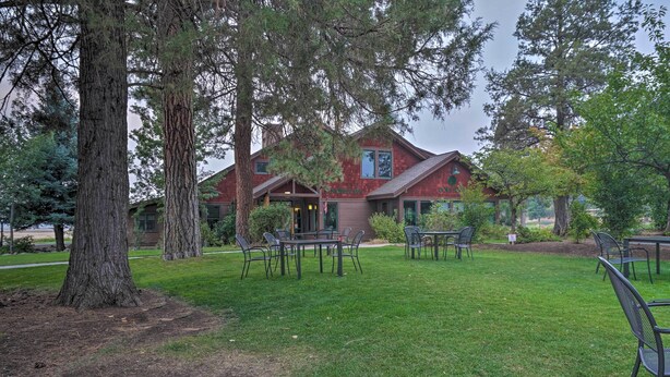 A lodge with a red exterior, outdoor seating area, and a well-maintained lawn. - Klamath Falls Townhome w/ Deck & Resort Amenities! (Klamath Falls)