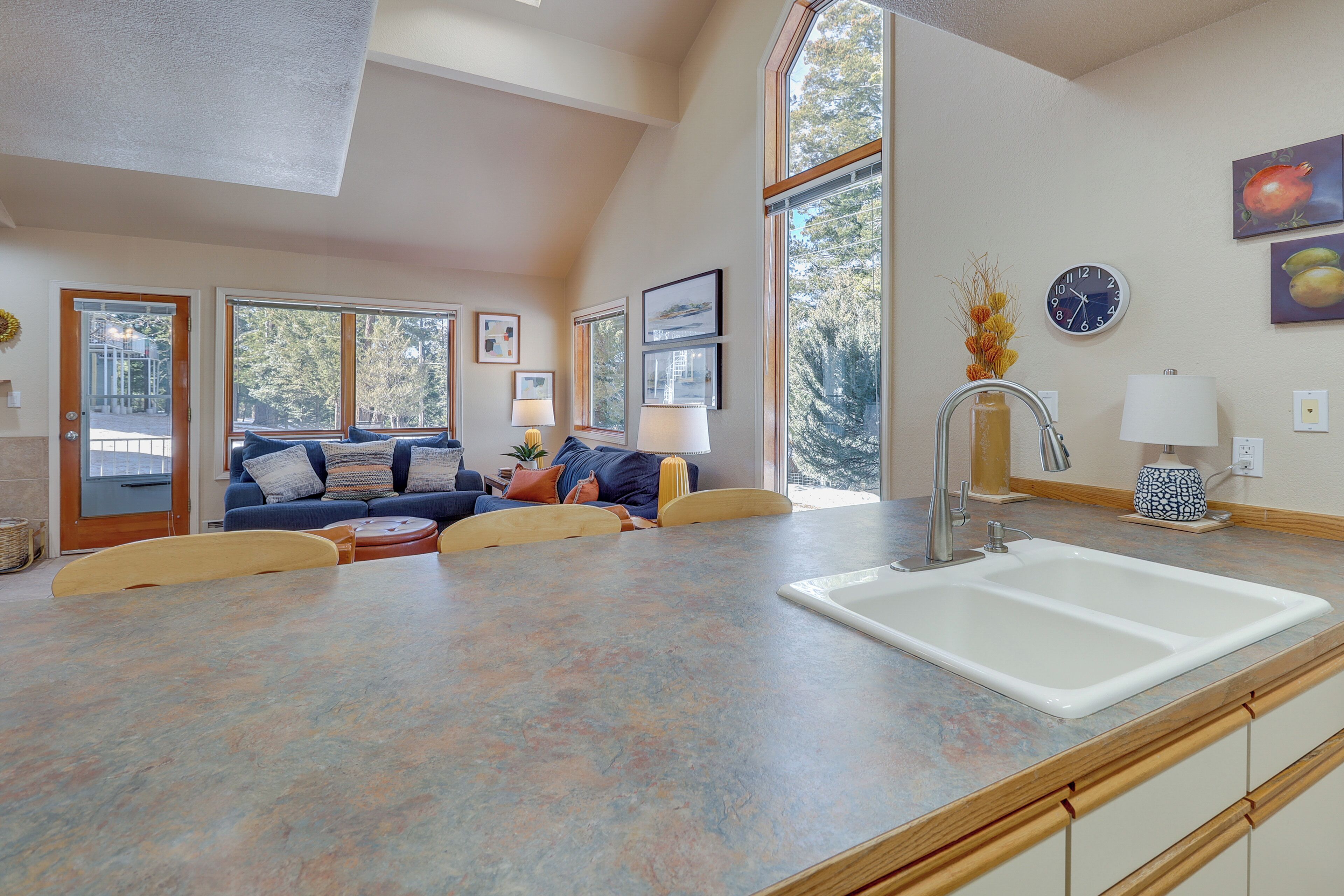 A spacious kitchen with a large island, a built-in sink, and a dining area with a table and chairs.