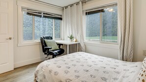 A bedroom with a bed, a desk, and two windows. - Walk to Beach & Lake Access: Cozy Redmond Apt! (Redmond)