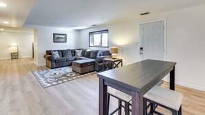A modern living room with a sectional sofa, a wooden dining table, and a rug. - Waynesville Studio Suite < 1 Mi to Downtown! (Waynesville)