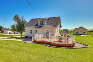 A single-story house with a front deck, a small porch, and a garage.