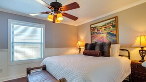 A bedroom with a bed, a ceiling fan, a painting, and a window with blinds. - On-site Lake Access + Fire Pit: Bonham Home! (Bonham)