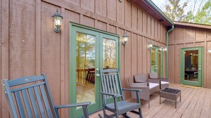 A wooden deck with outdoor furniture, including chairs and a table. - Peaceful Ellijay Cabin: Pool Access & Resort Perks (Ellijay)