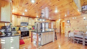 A spacious kitchen with wooden cabinets, stainless steel appliances, and a central island. - Waterfront Watauga Lake Home w/ Private Dock! (Butler)