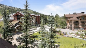 A lodge with multiple buildings, a parking area, and a mountainous backdrop. - 3313 - One Bedroom + Den Standard Powderhorn Lodge 1 Condo by RedAwning (Salt Lake City)