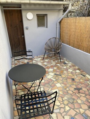 Relax on the patio with a round table and two comfortable chairs.