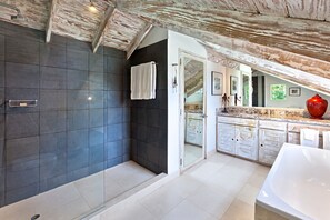 Bathroom features a glass shower enclosure and a towel rack.