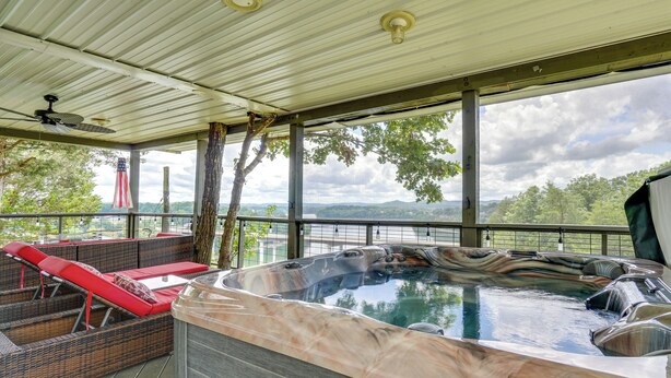 A hot tub with wicker seating and a view of a lake and mountains. - River-view Somerset Home: Large Deck, Fire Pit! (Somerset)
