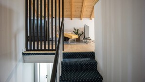 A staircase with a patterned carpet leading to a room with a bench and a plant. - Rooftop Studio apartment Yucca for 2+2, 2-min to the beach and 5 to Trogir (Trogir)