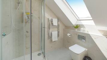 Shower, hair dryer, towels, shampoo