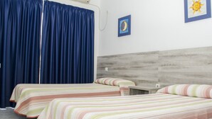 A room with two beds, a wooden headboard, a nightstand, and a wall-mounted air conditioner. - Pensión Pardo (Benidorm)