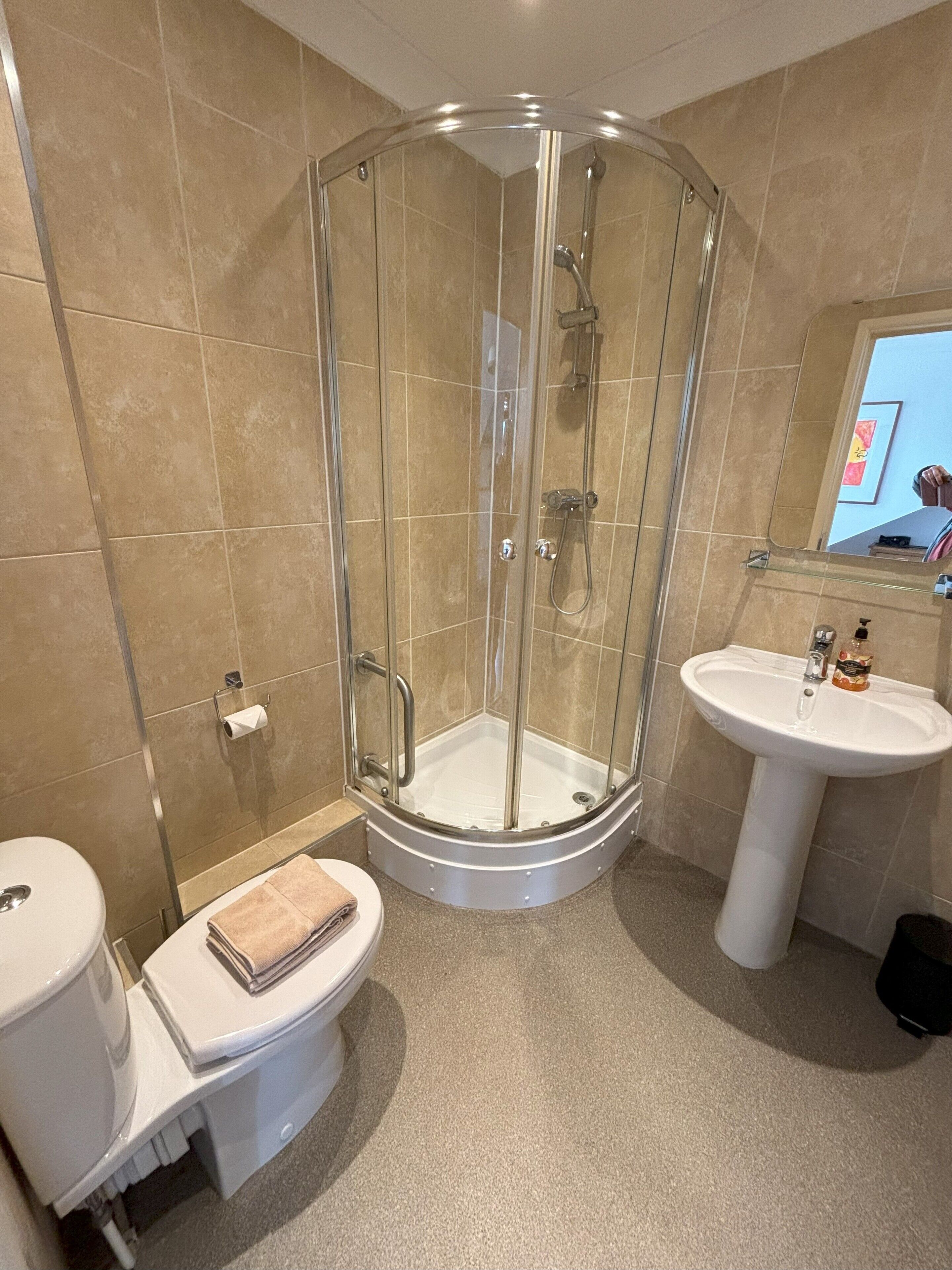 Shower, hair dryer, towels, soap