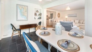 A dining area with a white table set for four, a ceiling fan, and a map on the wall. - Welcome to your personal slice of paradise (Placida)