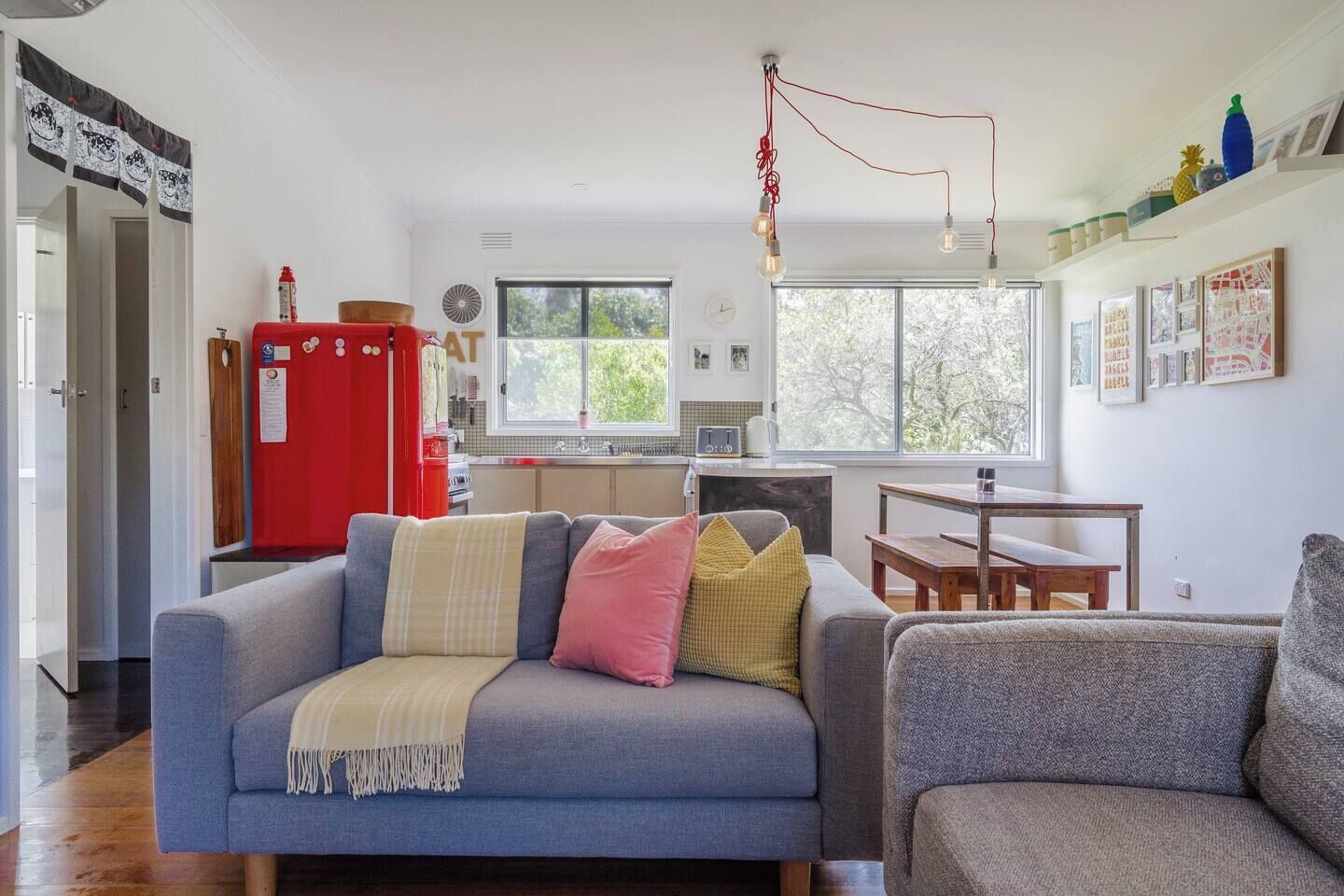 A sun-drenched open floor plan houses a kitchen, living and dining area.