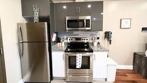 A modern kitchen with stainless steel appliances, a microwave, and a built-in oven.