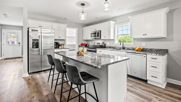 A modern kitchen with white cabinets, stainless steel appliances, a granite countertop, and pendant lighting. - Bourbon Trail Near Buffalo Trace-Hot Tub, Fire Pit, BBQ Grill (Frankfort)