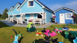 A blue house with a porch and a garage.