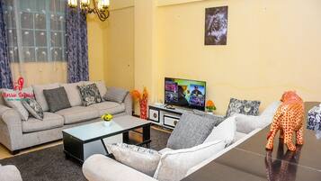 Business Apartment | Living area | 24-inch Smart TV with digital channels