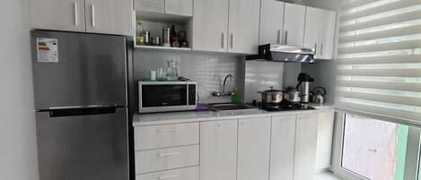 Fridge, microwave, coffee/tea maker, cookware/dishes/utensils