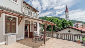 A terrace with a pergola, a dining table, and chairs. - Apartma Most - accommodation with breathtaking views of the rivers, village and mountains (Most na Soči)