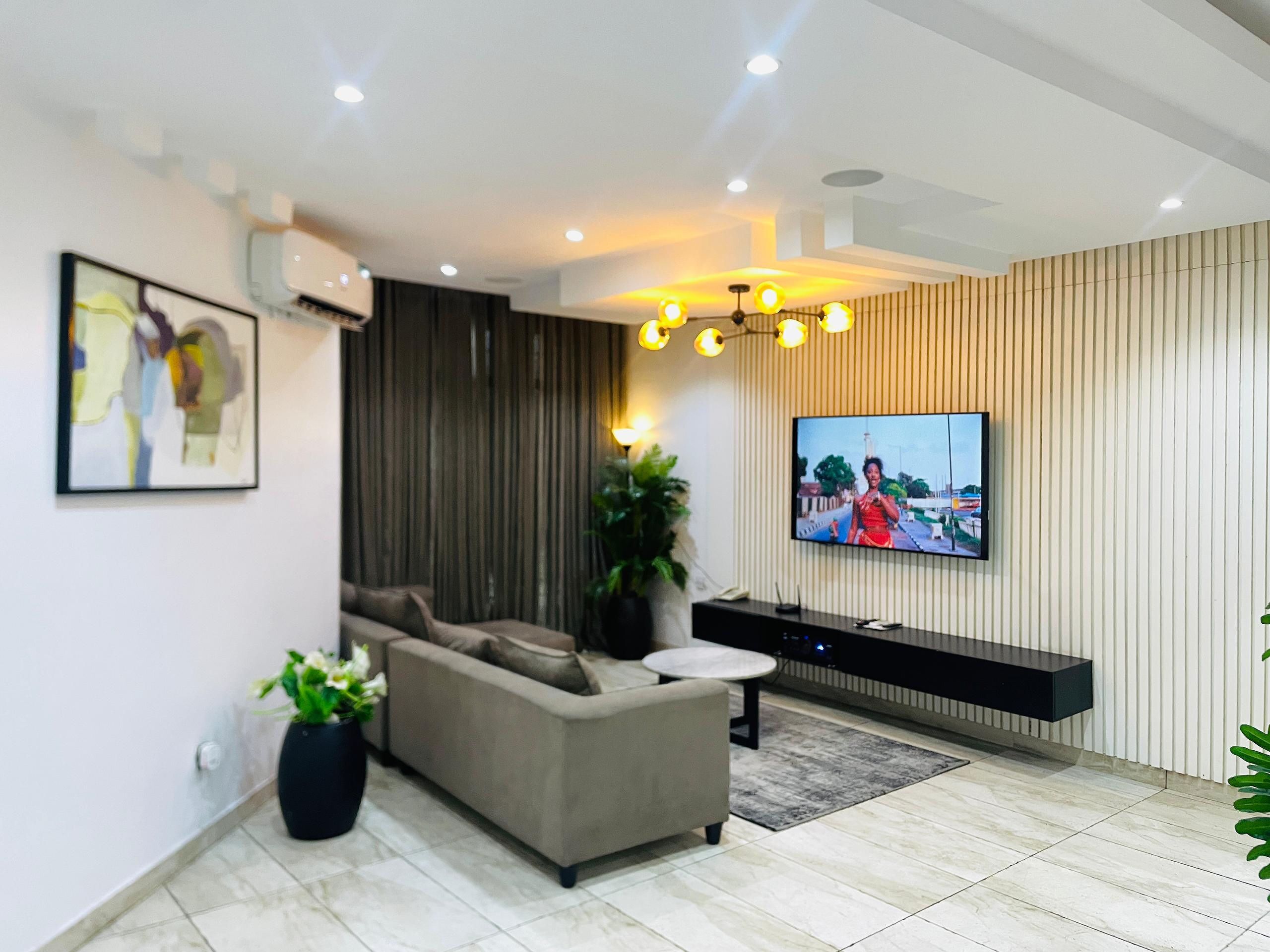 Executive Apartment | Living area | 50-inch Smart TV with cable channels