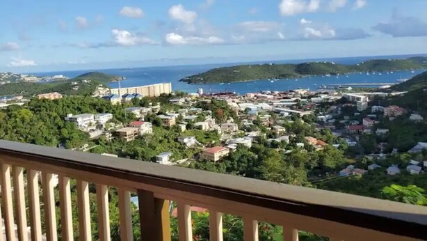 A coastal town with a view of the sea and hills. - Sea View One-Bedroom Apartment in St. Thomas

 (Charlotte Amalie West)