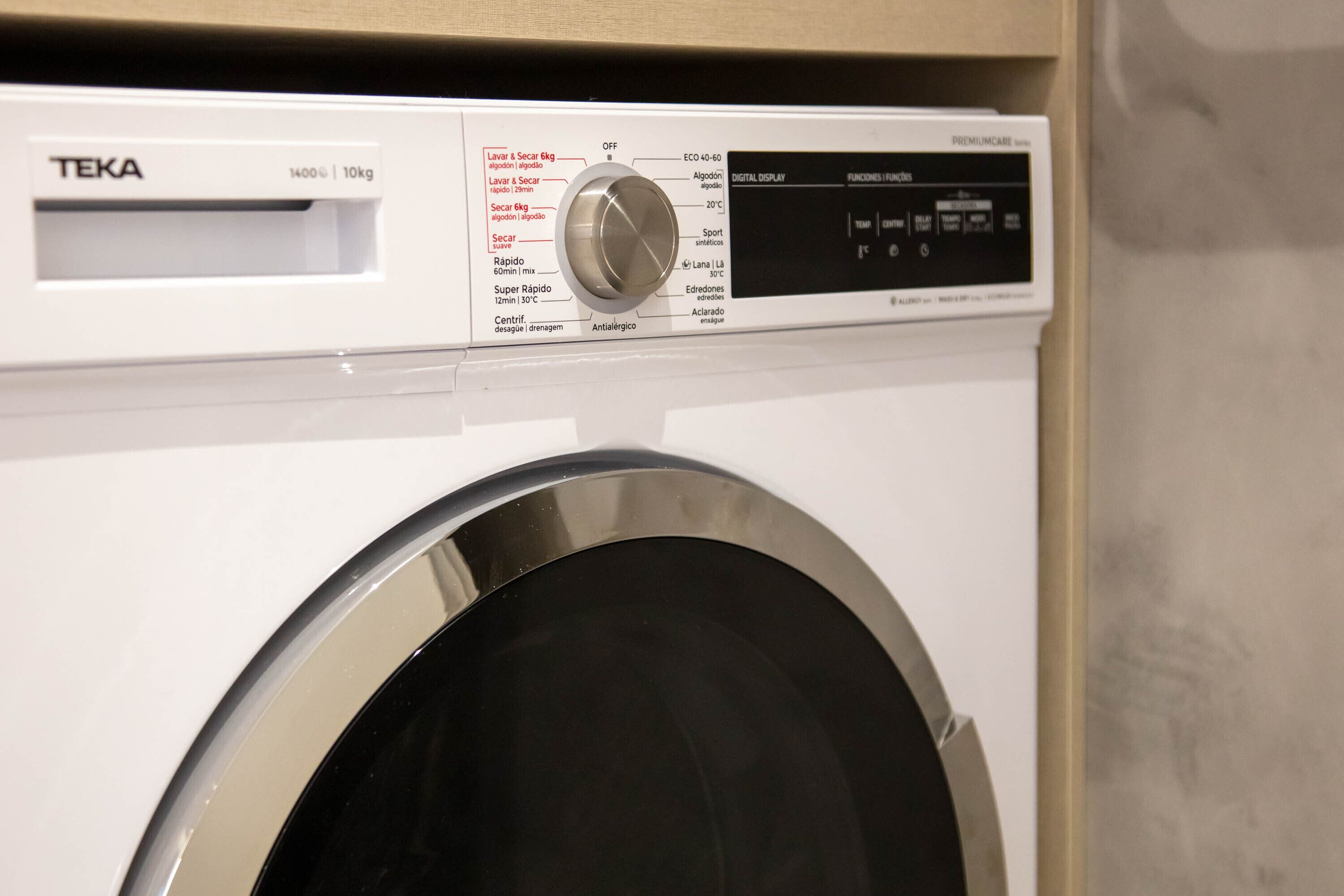 A front view of a TEKA washing machine with a digital display and control panel.