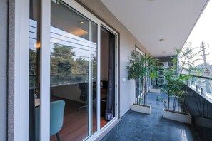 Super Deluxe King Bed room with Balcony | In-room safe, desk, blackout drapes, soundproofing - Nikko Premier - Near Medanta Hospital (Gurugram)