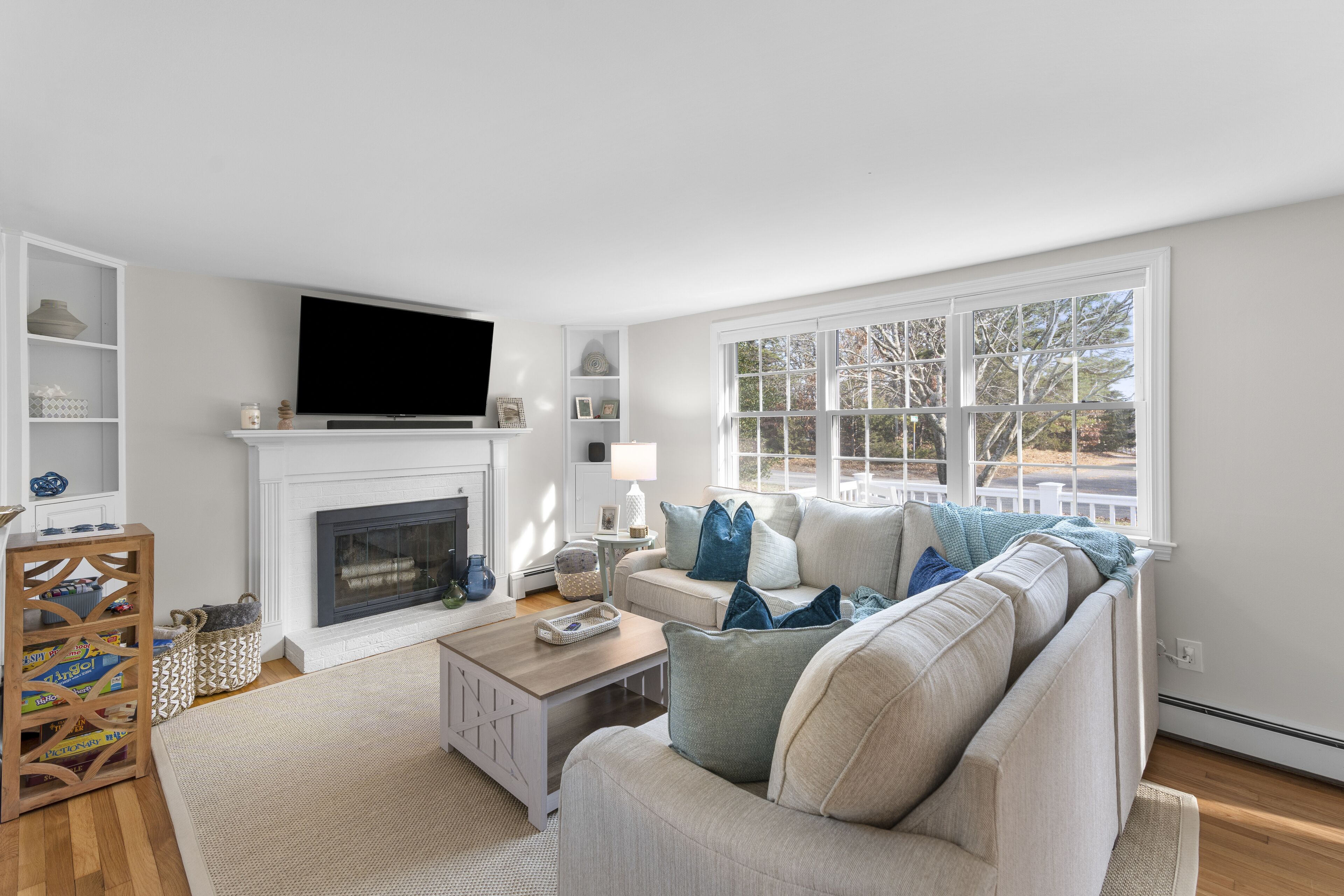 A living room with a fireplace, a television, a sofa, and a coffee table.