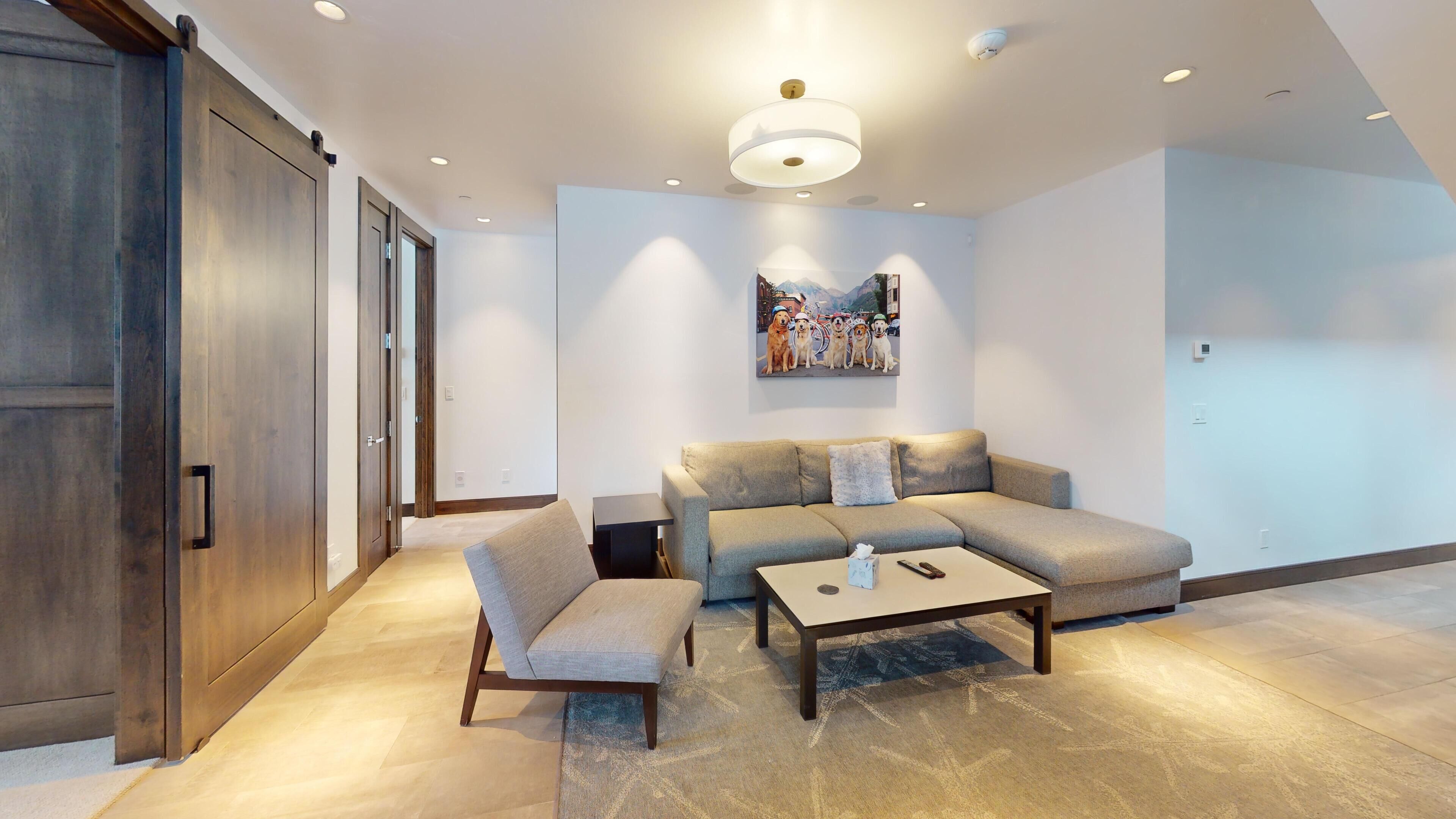 A modern living room with a sofa, a coffee table, and a bench.