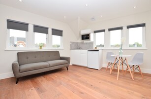 Split Level Deluxe Studio Apartment | Living area | Flat-screen TV, heated floors