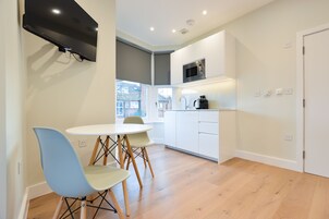 Standard Studio Apartment | Living area | Flat-screen TV, heated floors