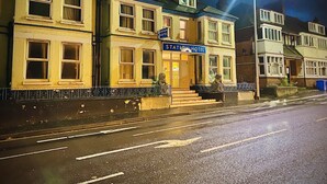 A hotel with a prominent 'Station Hotel' sign, a traditional facade, and a well-lit entrance. - Station Hotel (Norwich)