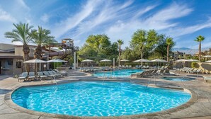 A pool area with multiple pools, lounge chairs, umbrellas, and palm trees. - Modern 1BR Villa at The Westin Desert Willow Villas – Golf Views + Resort Pools (Palm Desert)