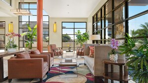 A spacious lobby with a large seating area, a coffee table, and potted plants. - Modern 1BR Villa at The Westin Desert Willow Villas – Golf Views + Resort Pools (Palm Desert)