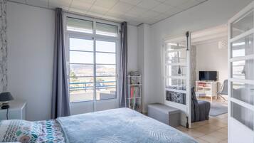 1 dormitorio y tabla de planchar con plancha