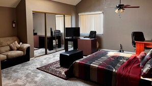 A bedroom with a bed, a desk, a chair, a sofa, a ceiling fan, and a window. - Adorable Home for Family. (Stockton)