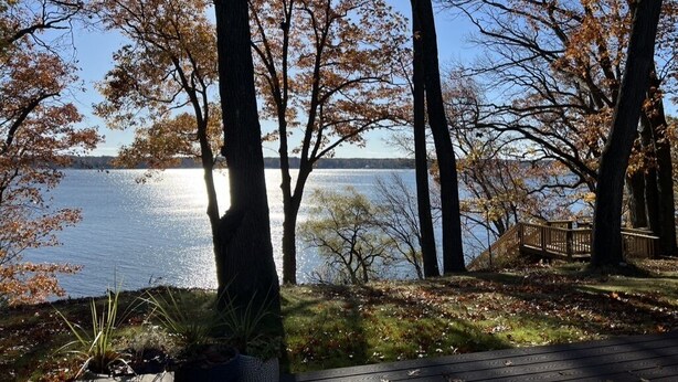 A lakeside deck with trees and a wooden walkway. - The Perfect Place: Close to town, with 100' of private lake frontage. (Montague)