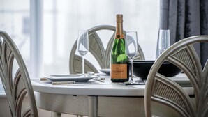 A table with a bottle of champagne, two glasses, and a menu.
