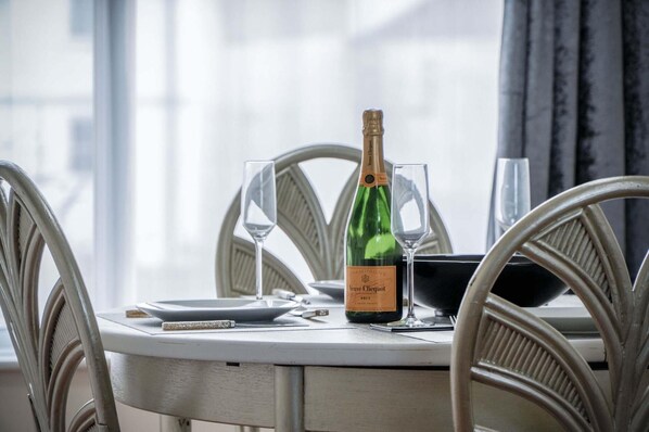 A table with a bottle of champagne, two glasses, and a menu.
