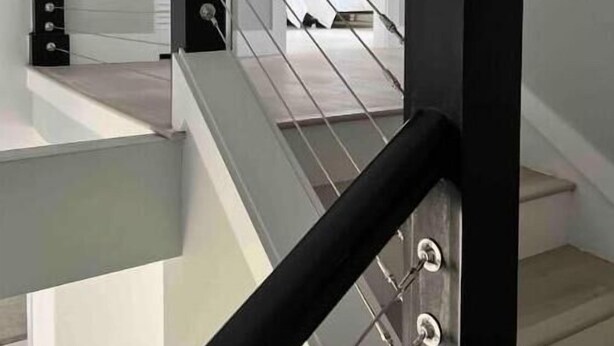 A staircase with a black handrail and glass balustrade, leading to a landing with a white door. - Perfect for Golfer's, P-baller's and Beach Goer's! (Hilton Head Island)
