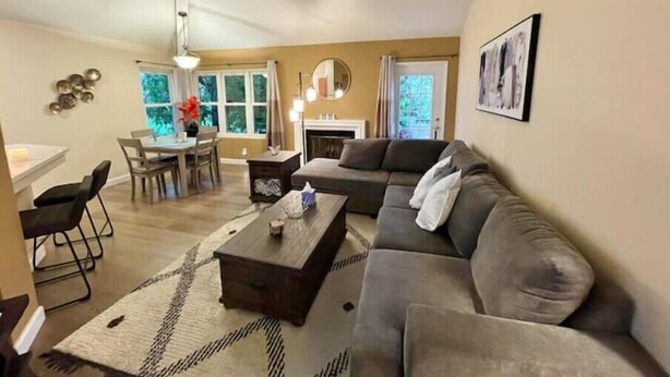 A living room with a sofa, coffee table, and dining area with chairs and a table. - Beautiful Laguna 2 Bedroom Condo (Laguna Niguel)