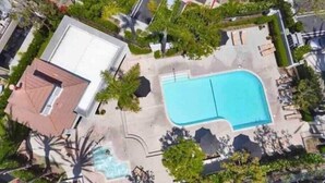 An aerial view of a residential property with a swimming pool, a patio area, and a small garden with palm trees. - Beautiful Laguna 2 Bedroom Condo (Laguna Niguel)