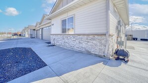 A modern single-story house with a stone foundation and a sloped roof. - The Jolly Rancher, Luxury Amenities, Corporate and Vaca (Twin Falls)