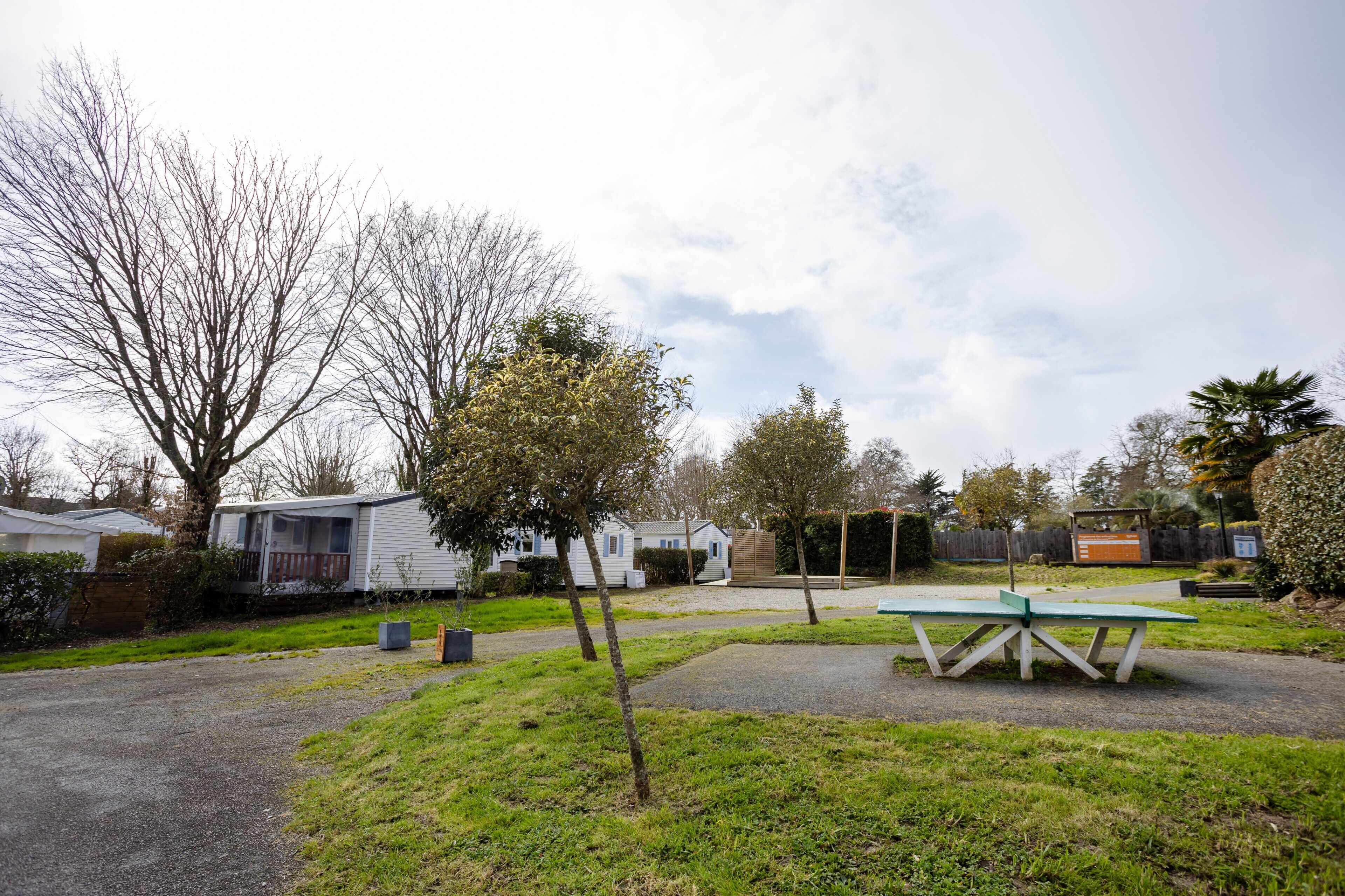 Un camping con casas móviles, una mesa de picnic y una zona verde.