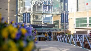 A modern building with a sign reading "The Oracle" and "House of Fraser" at the entrance.
