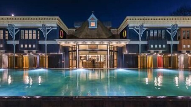 A hotel with a large pool in the foreground, a central entrance with a roof, and multiple windows on the facade. - Elegant Period Apartment for 3, Free Parking, Central (Reading)